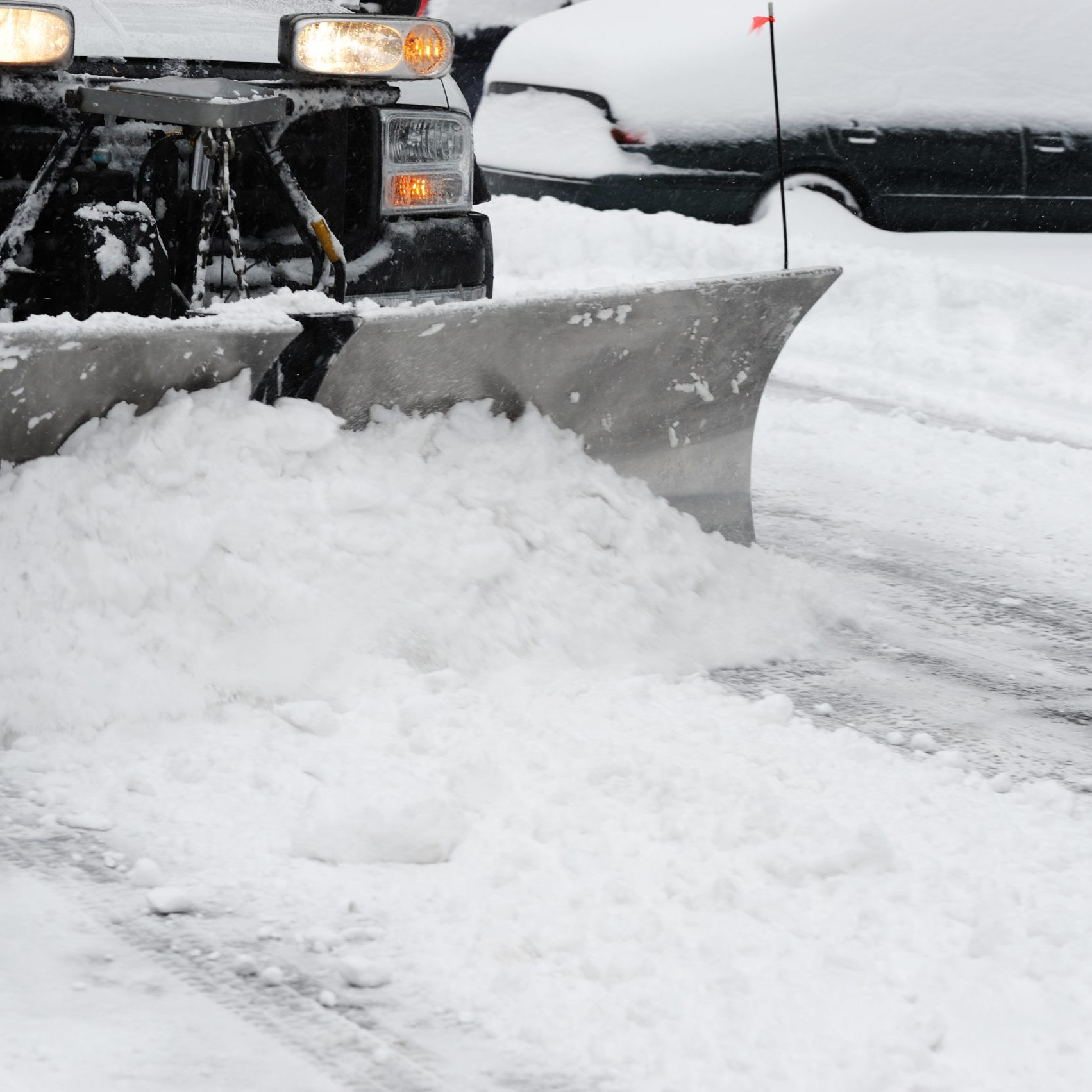 snowplow removing snow on the street after blizzard